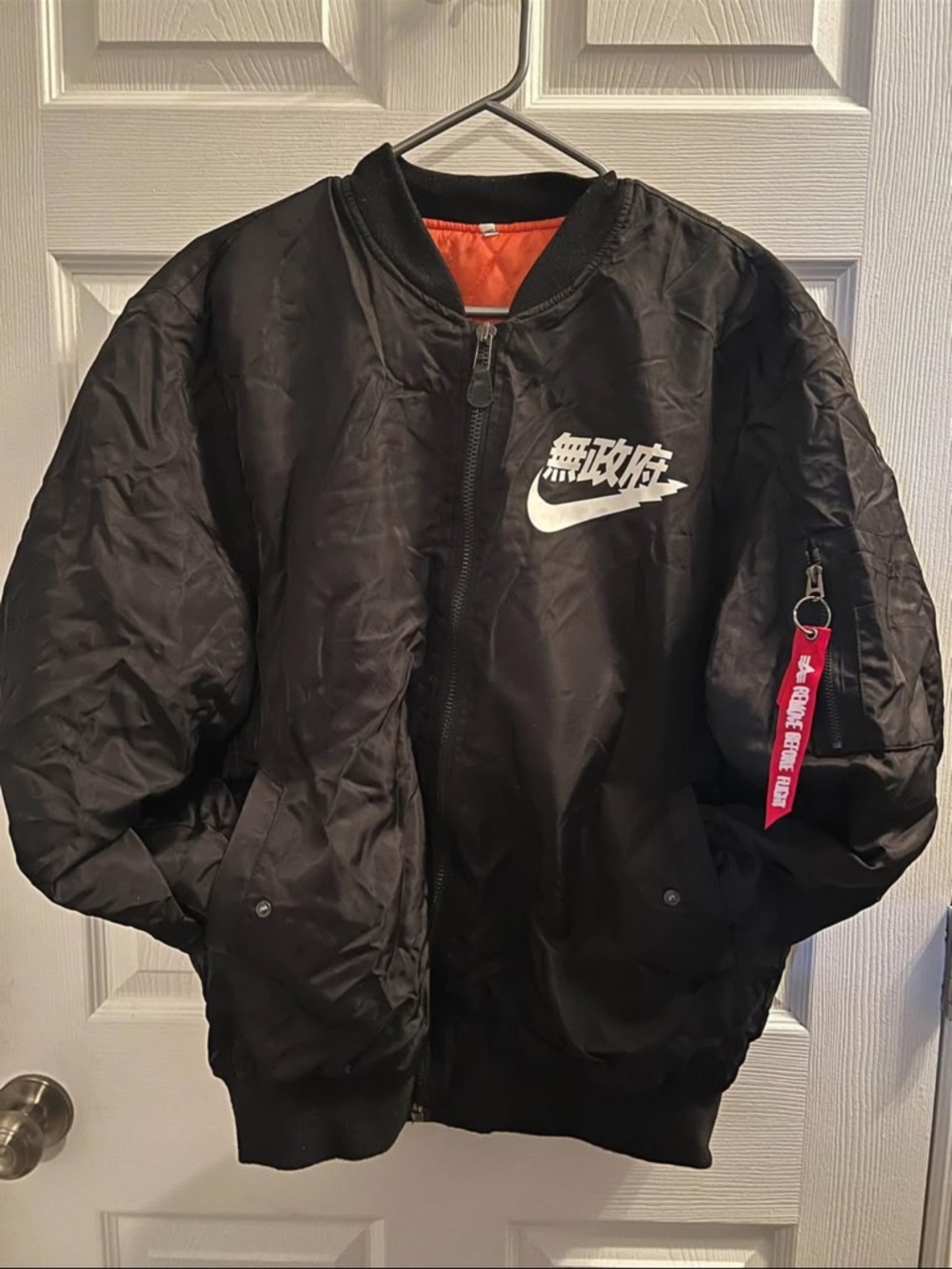 Nike Black Bomber Jacket with White Logo and Red Zip Tag